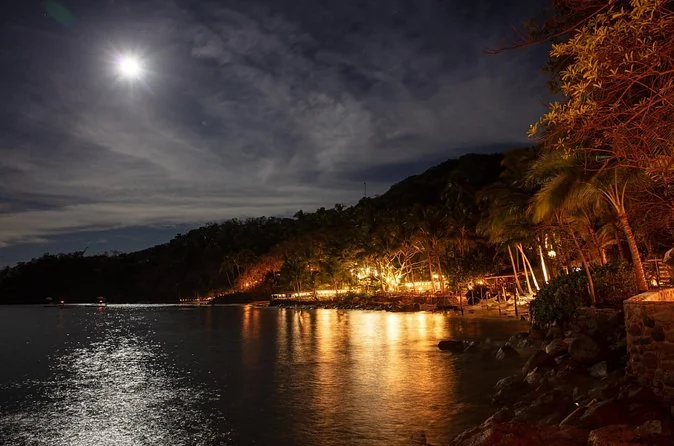The lights of Las Caletas glowing along the shore at night